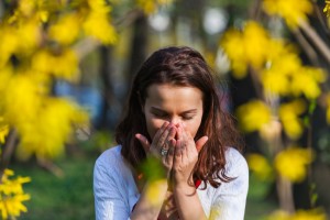 Woman with allergy sneezing